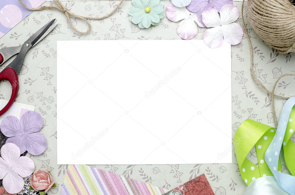 creative work space with a white sheet in the center, scrapbooking