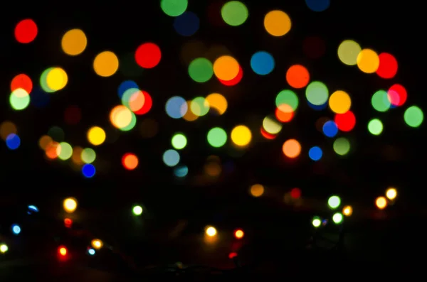 Renkli ışıklar siyah bir arka plan bulanık. Bokeh, yumuşak odak