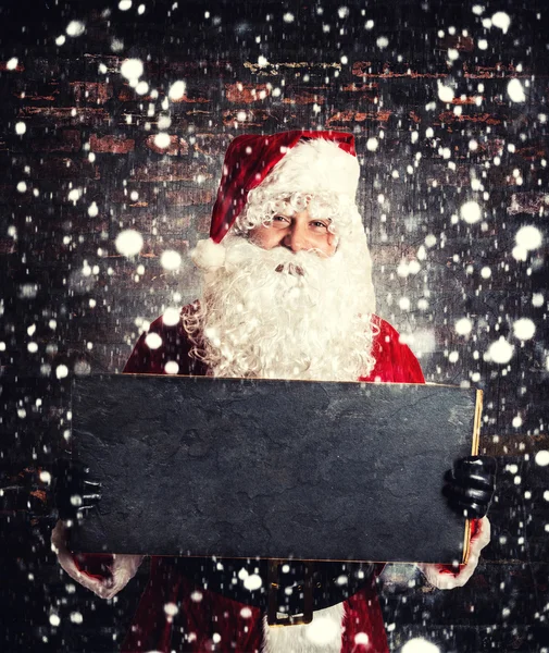 Санта-Клаус с доской — стоковое фото