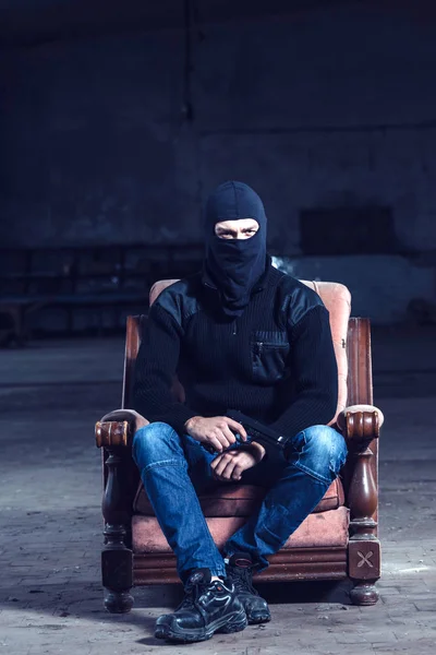 Terrorist sitting in old chair — Stock Photo, Image