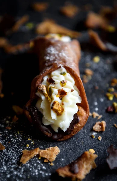 Sweet homemade cannoli with sliced pistachios and ricotta,selective focus
