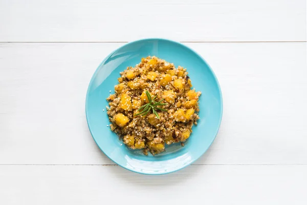 Plate of buckwheat stew with pumpkin on white table — Stock Photo, Image