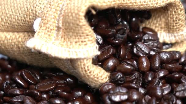 Grain roasted coffee to spill from the bag jute — Stock Video