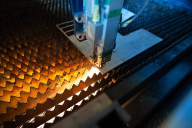 Plasma laser cnc industrial machine cutting metal and steel in metalworking workshop.