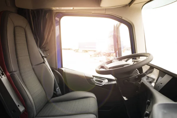 Truck vehicle interior with driver seat and steering wheel. Truck drivers wanted. Professional drivers job opening and career.