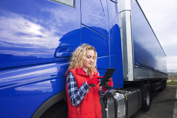 Professionele vrachtwagenchauffeur het opzetten van navigatie voor bestemming. Controleer zijn route op de tablet computer en sta klaar voor lang voertuig. Vervoer dienst. — Stockfoto