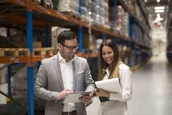 Zakenmensen in het magazijn. Managers die een opslagcentrum bezoeken en discussiëren over distributie en doelen voor volgend jaar. — Stockfoto