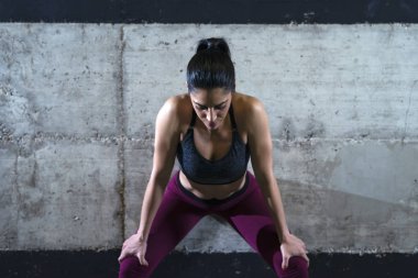 Fitness woman concentrating and getting motivated for training.