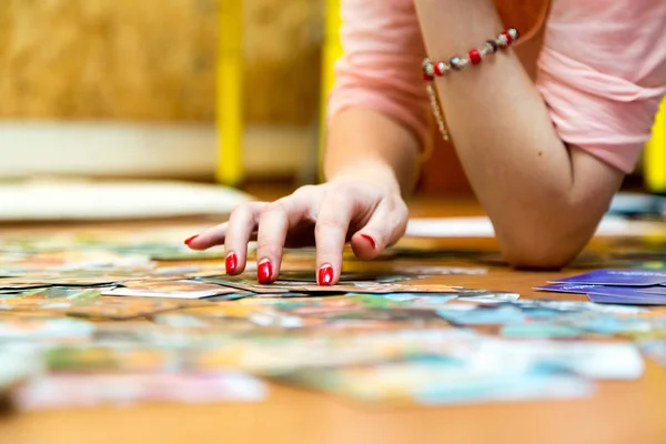 A woman\'s hand with red nails sorts out metaphorical associative maps