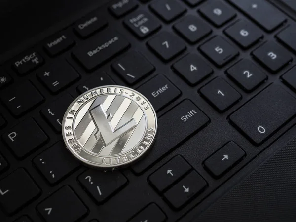 Digital currency physical silver litecoin coin on white computer
