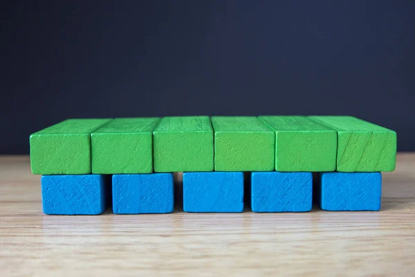 Wooden toy cubes on a brown wooden background