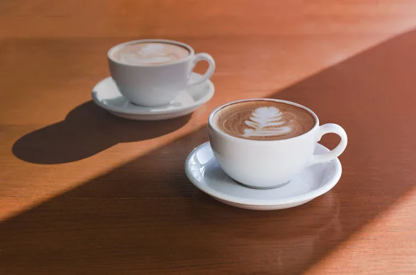 Two morning cups of coffee on wooden background — 图库照片
