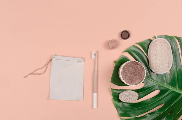 Set of everyday care of ecological products on tropical monstera leaf. Zero waste concept. Flat lay