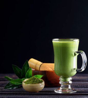 Koyu ahşap arka plan cam bardakta Matcha yeşil çay kahve içecek