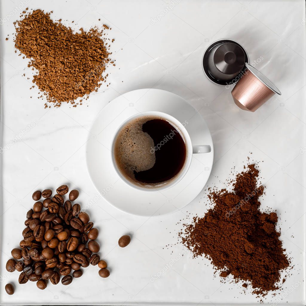 Espresso cup, coffee beans, ground coffee, coffee capsule and instant coffee on a white background