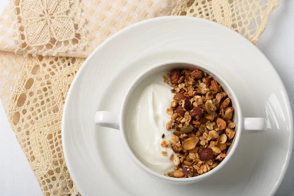 Healthy breakfast: Greek yogurt with homemade granola in a white bowl