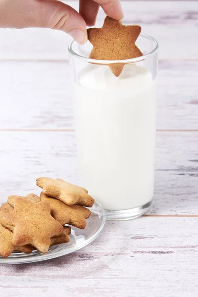 Ginger biscuits with milk. Glass beaker