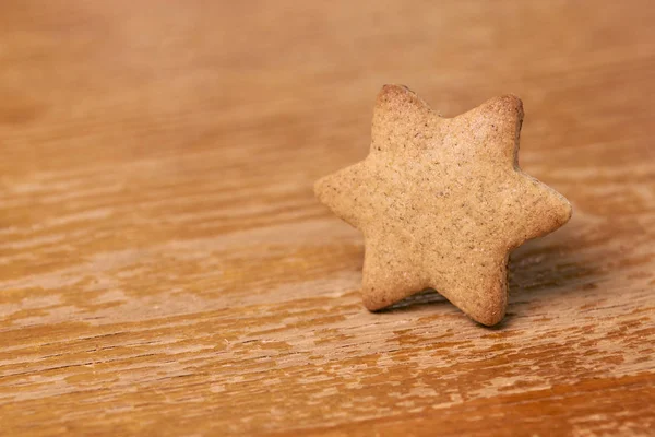 One star. Gingerbread Cookie. Brown background