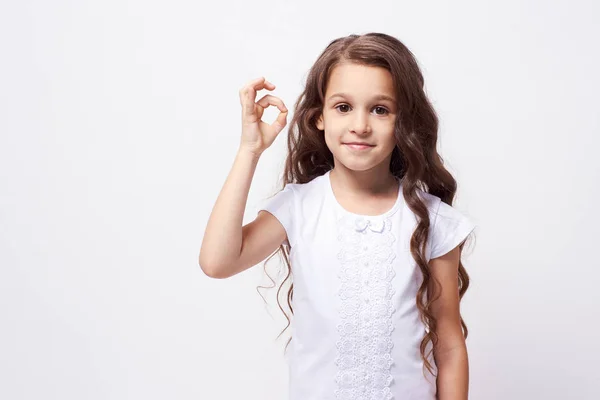 Gesture approval. Little girl. White background. Brunette — Stock Photo, Image