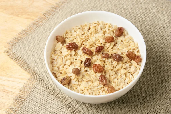 Delicioso desayuno saludable. Fondo neutro. Harina de avena con pasas —  Fotos de Stock