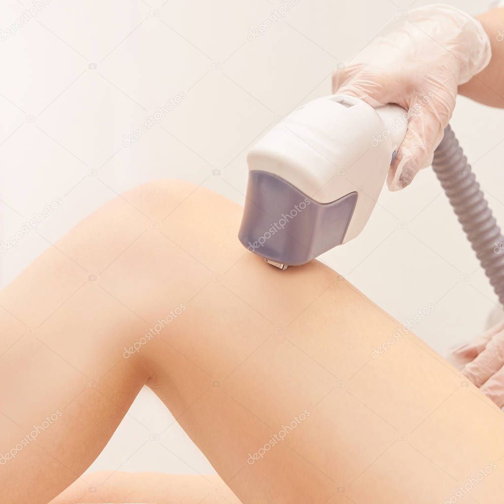 Laser elos medical device. Remove unwanted hair and asteriks. Cosmetology spa procedure at salon. Doctor laser leg depilation. Perfect treatment