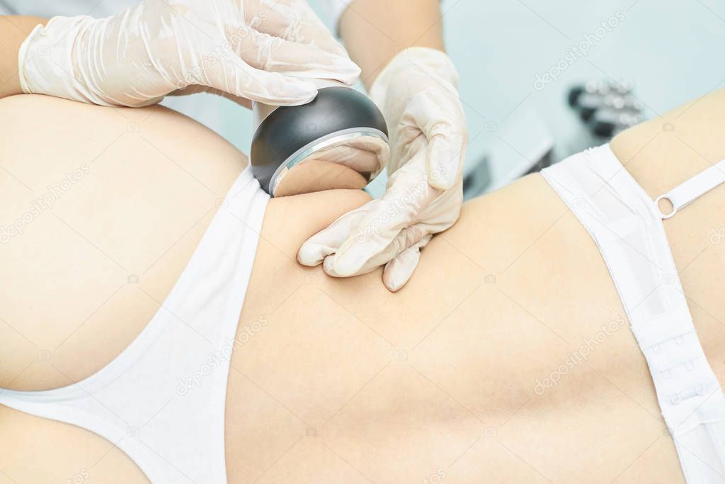 Cavitation rf body treatment. Female ultra sound lipo machine. Spa contouring. Doctor hands