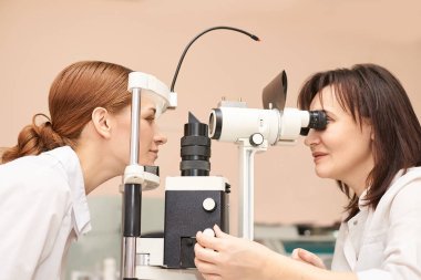 ophthalmologist doctor in exam optician laboratory with female patient. Eye care medical diagnostic. Eyelid treatment clipart