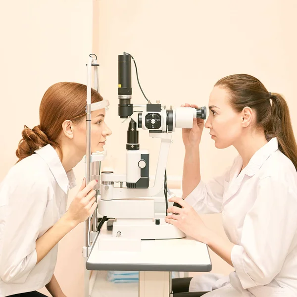 Ophthalmologist doctor in exam optician laboratory with female patient. Eye care medical diagnostic. Eyelid treatment — Stock Photo, Image