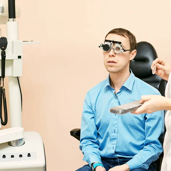 Ophthalmologist doctor in exam optician laboratory with male patient. Men eye care medical diagnostic. Eyelid treatment — Stock Photo, Image