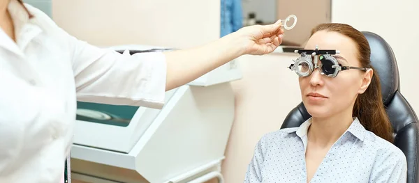 Ophthalmologist doctor in exam optician laboratory with female patient. Eye care medical diagnostic. Eyelid treatment — Stock Photo, Image