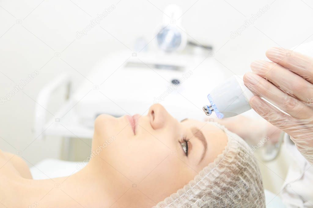 Dermatology skin care facial therapy. Medical spa anto wrinkles procedure. Woman face rejuvenation. Pretty girl. Rf cosmetician equipment
