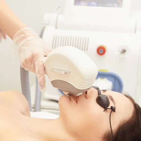 Laser elos medical device. Remove unwanted hair and asteriks. Cosmetology spa procedure at salon. Chin facial depilation