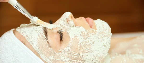 chemic facial peel mask. Cosmetology acne treatment. Young girl at medical spa salon. Brush. Face fruit acid. Sensitive peeling