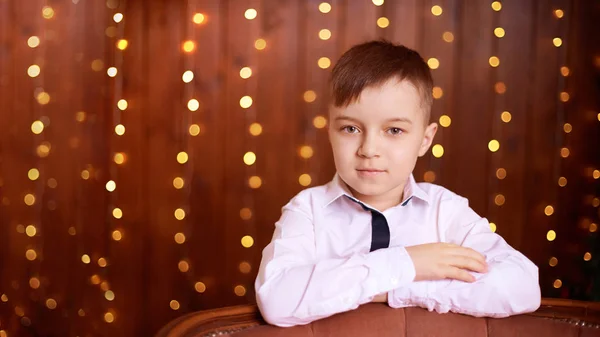 Christmas happy boy. Luxury attractive red hair child. Xmas miracle. Green tree, lights, bokeh, new year interior — 스톡 사진