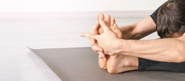 Yoga man at paschimottanasana. Class for exercise or fitness strength — 스톡 사진