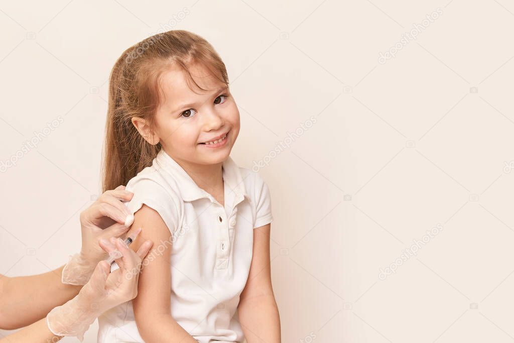 Doctor do injection to young girl. Kid immunization