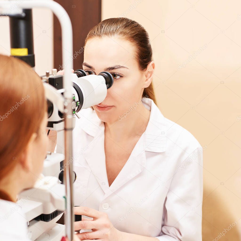 ophthalmologist doctor in exam optician laboratory with female patient. Eye care