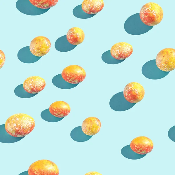 Golden red eggs. Pattern at blue background. Easter concept