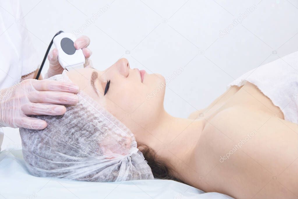 Ultrasonic cleaning of the face. Modern equipment. Cosmetic women procedure