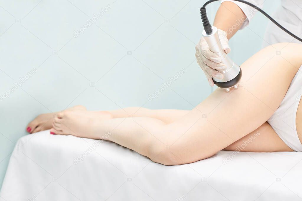 Perfect body radio treatment. Woman at spa procedure. Doctor hand and girl body