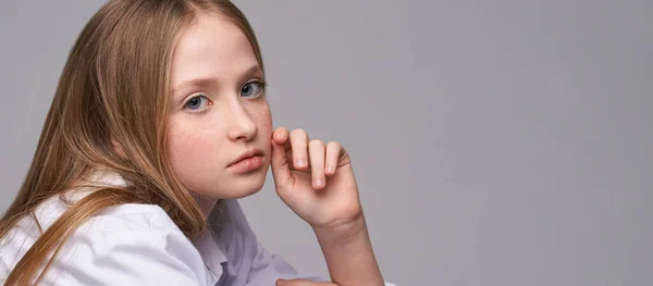 Young beautiful girl. Serious model with hand near face — Stock Photo, Image