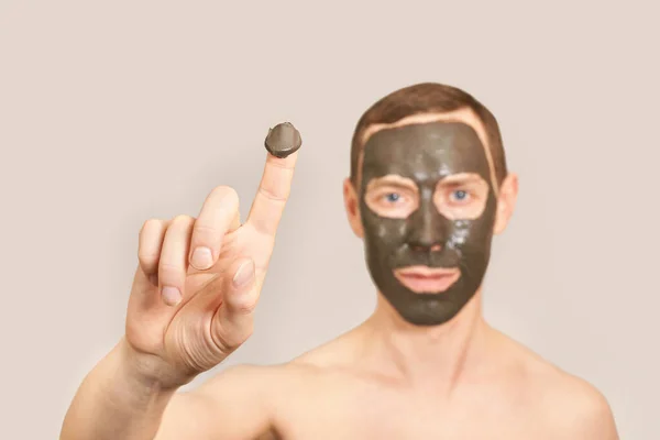 Black Clay Mask on the Guy Face