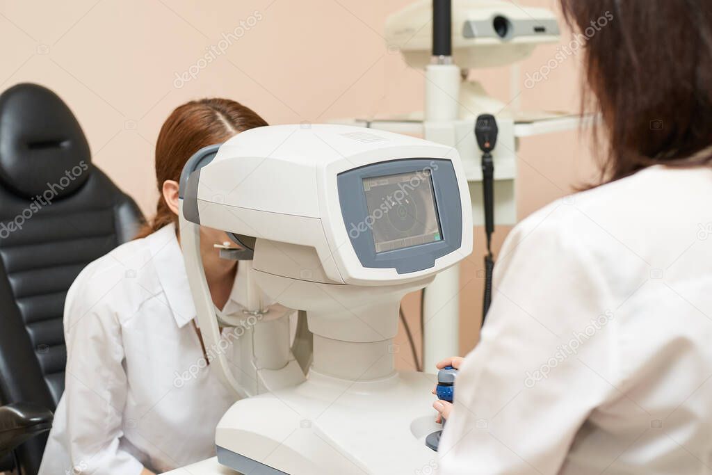 ophthalmologist doctor in exam optician laboratory with female patient