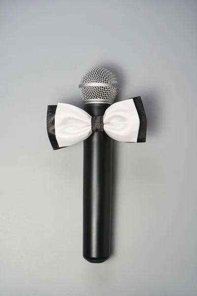 Boy and girl microphone concept. Grey background