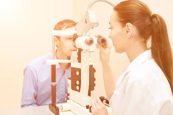 Szemész orvos a vizsgálat optikus laboratóriumban férfi beteggel. A férfiak törődnek — Stock Fotó