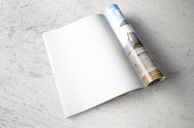 Gri beton zemin üzerine dergisinin temiz açılan sayfa