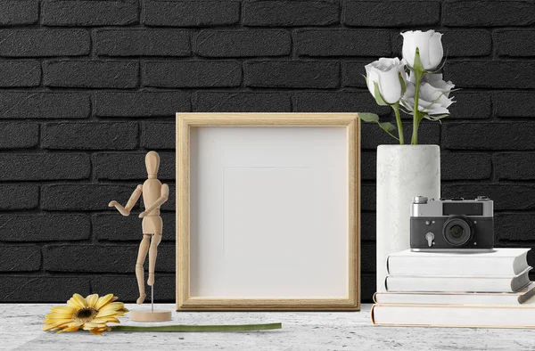 empty photo frame with flowers and camera on books