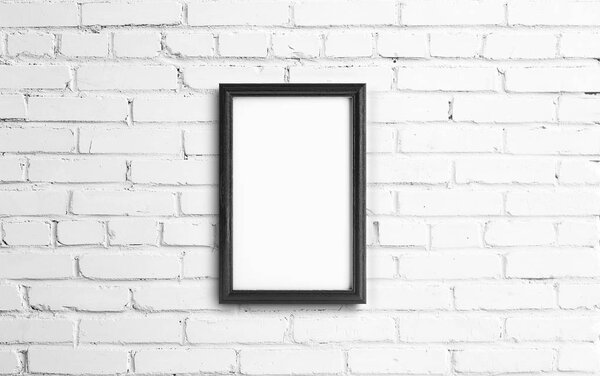 Empty dark photo frame on brick background