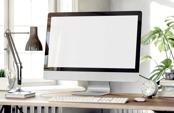 white empty computer screen with table lamp and books on desktop