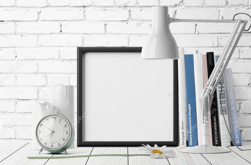 empty photo frame with pile of books and alarm clock with table lamp